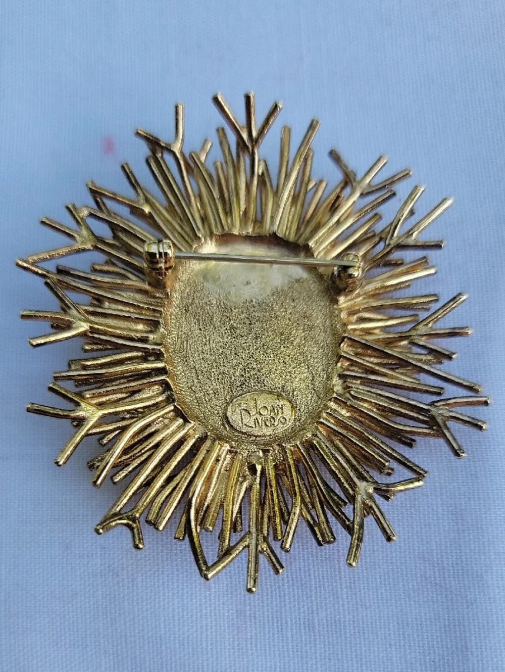 Vintage Joan Rivers Gold Sunburst Brooch with Coral Center